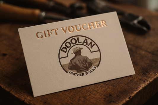 Gift voucher for Doolan Leather Works on a wooden surface